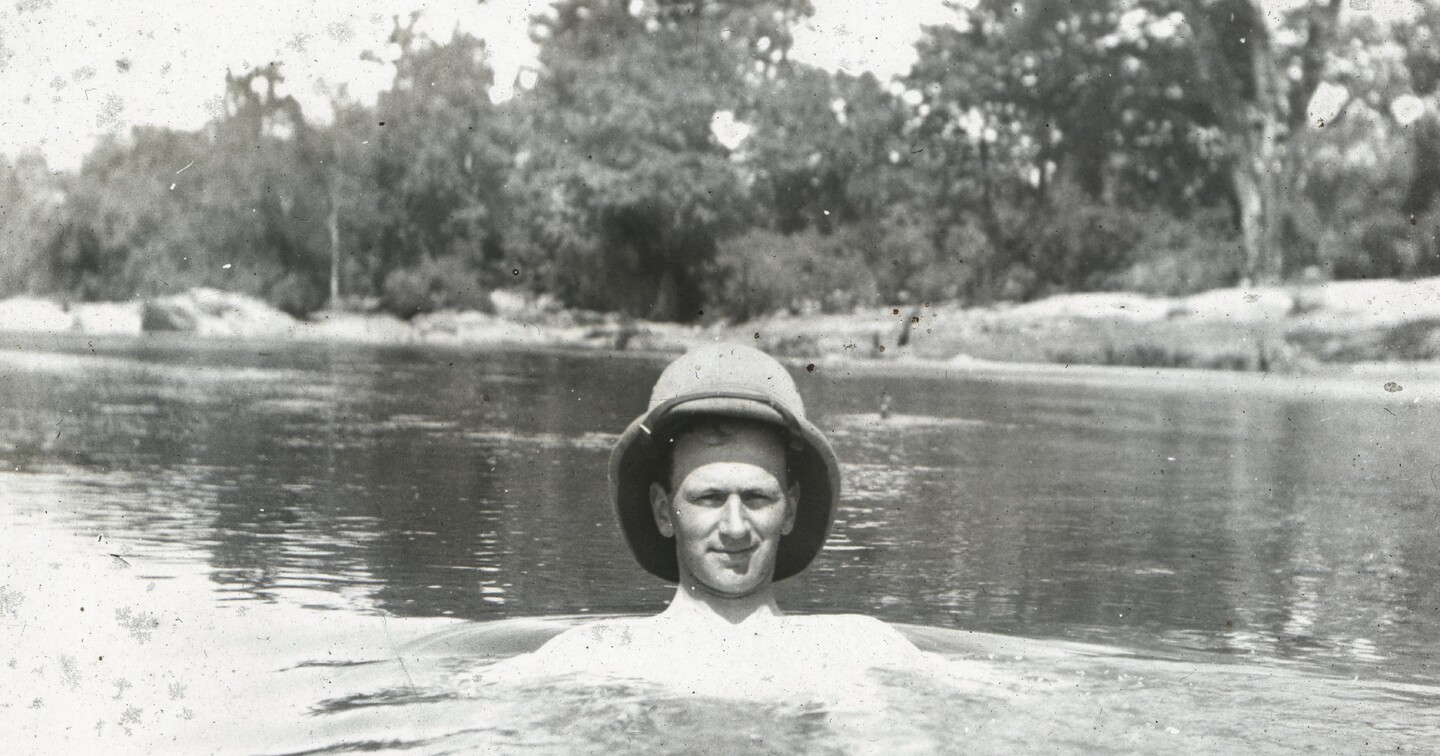 Figure 1. The Revd Gerald Dickson (wearing topi) bathing in river.