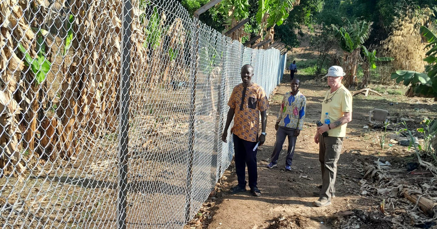 At the security fence for Yei Vocational Training College, in South Sudan, funded with help from Bishops’ Appeal, are Morris Logulomo, manager, Tom Finlay from St John’s parish, Moira, and Baraka, an instructor from the college.  Photo credit: CMS Ireland.