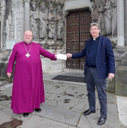 Bishop Colton presents fund&ndash;raising proceeds to the Dean of Cork to mark 150th anniversary of St Fin Barre&rsquo;s Cathedral