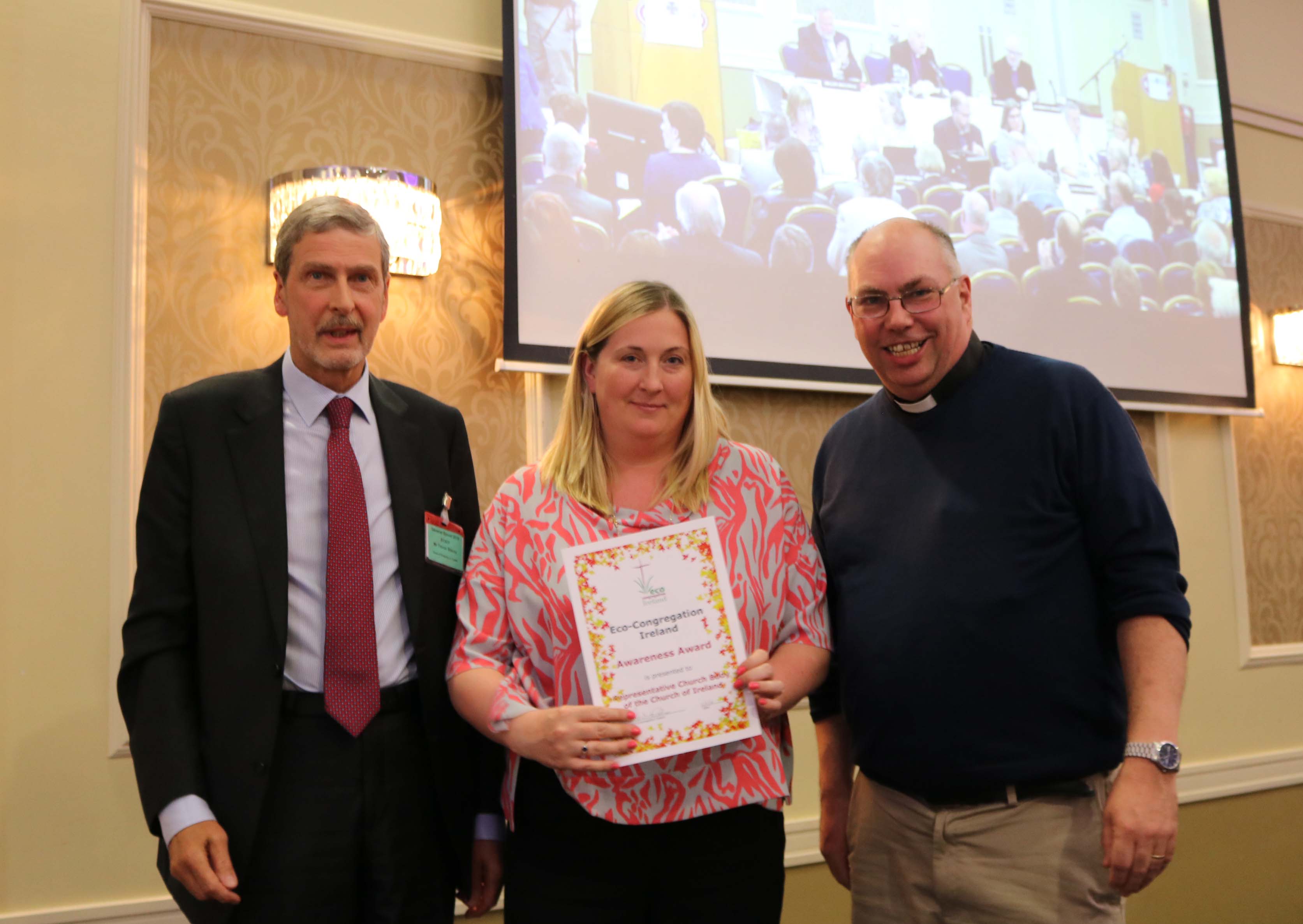 Archdeacon Andrew Orr, Chair of Eco Congregation Ireland, presents an Eco Congregation awareness award to Sarah Dunne, Manager &ndash; Investment Portfolio and ESG, and Trevor Stacey, Head of Property, Representative Church Body.