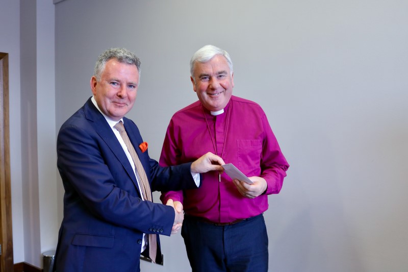 Bishop David McClay accepts a prize for The Columban.