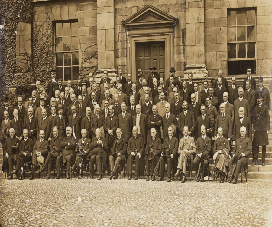 Group portrait of the members of the Irish Convention at Trinity College, taken on 21 August 1917, at front of building [Dining Hall?] in courtyard'. This image is reproduced courtesy of the National Library of Ireland, NPA Conv.