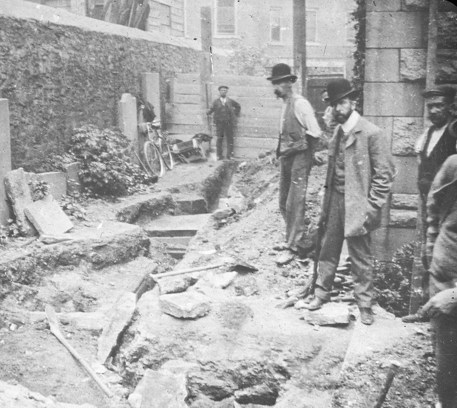 This is a similar shot to the previous image, but shows a glimpse of buildings outside the graveyard in the background.