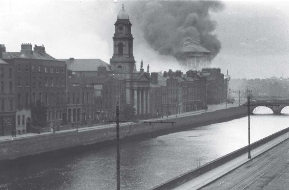 Dark smoke from the Four Courts dome mixes with white smoke from the PROI Record Treasury out of shot to the left, 30 June 1922. Reproduced with the permission of the Irish Architectural Archive.. &copy; Irish Architectural Archive, 10/35 V 1