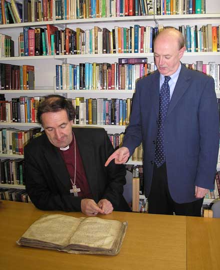 Dr Raymond Refausse shows the Red Book of Ossory to the Bishop of Cashel & Ossory