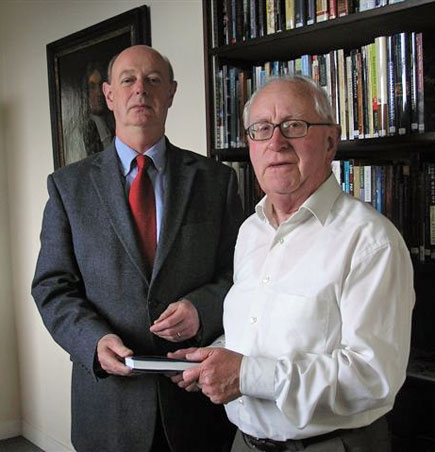 Dr Raymond Refauss&eacute; accepts a copy of 'A History of Glasnevin' from Mr Tony O'Doherty