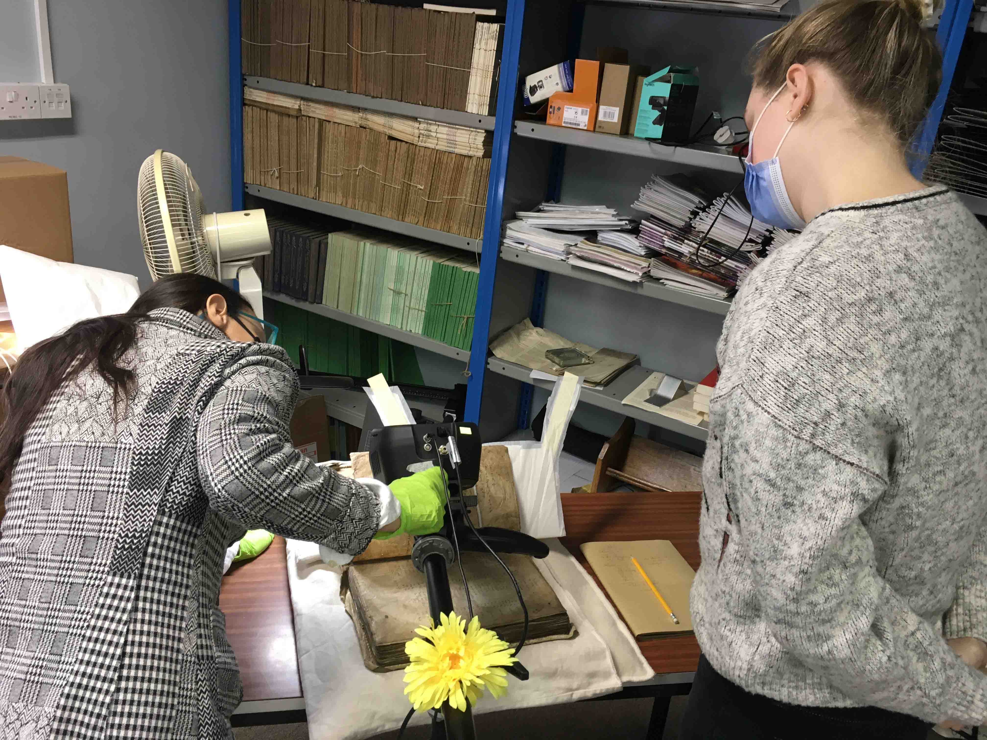 Professor P&aacute;draig &Oacute; Mach&aacute;in's PhD students (left) Veronica Biolcati, from Italy, working with (right) Anna Hoffmann, from New York, as they position the XRF scanner over the Red Book in the RCB Library.