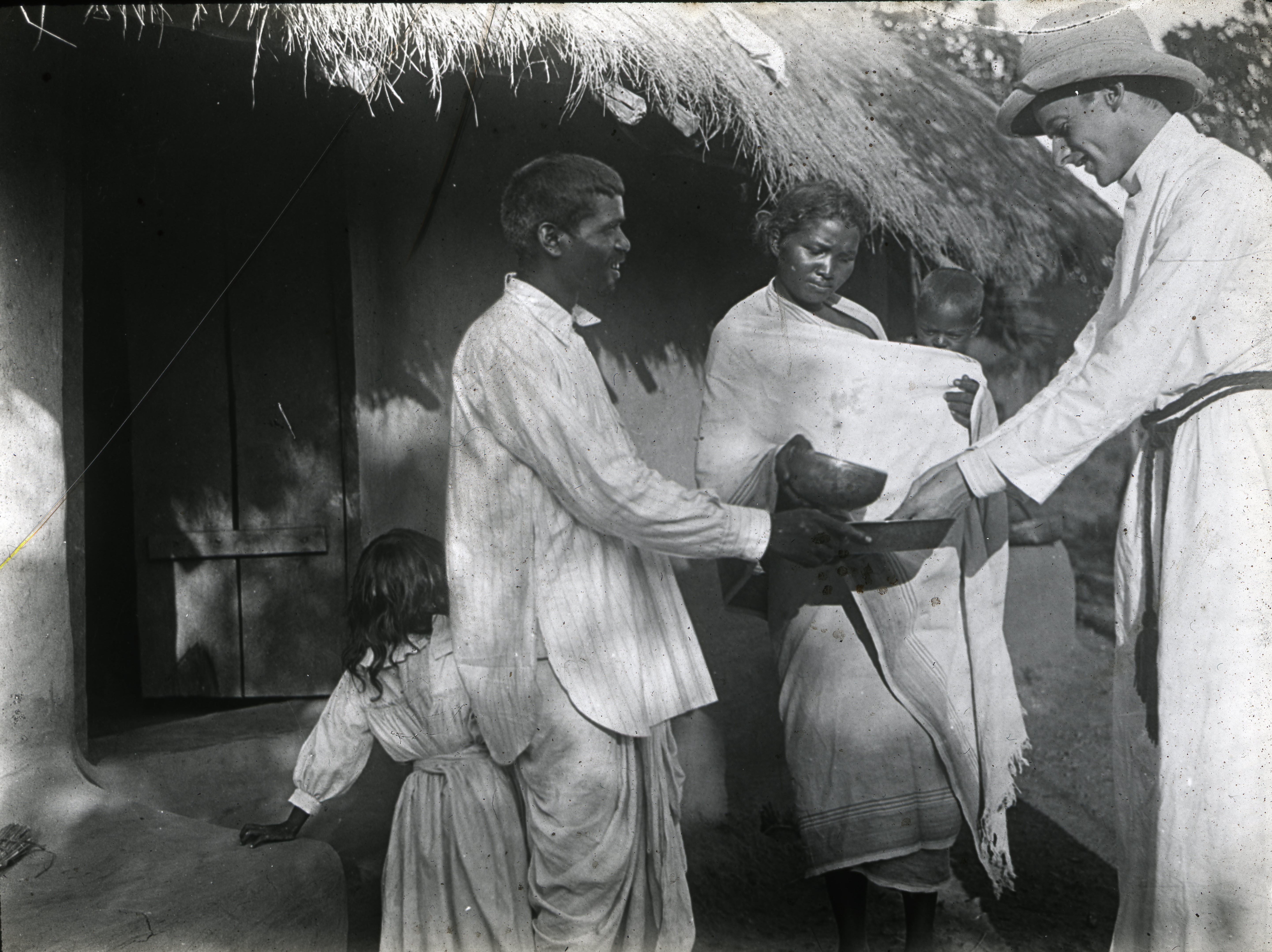 Figure 7. Couple welcoming the Revd Dickson to their home -washing his hands.