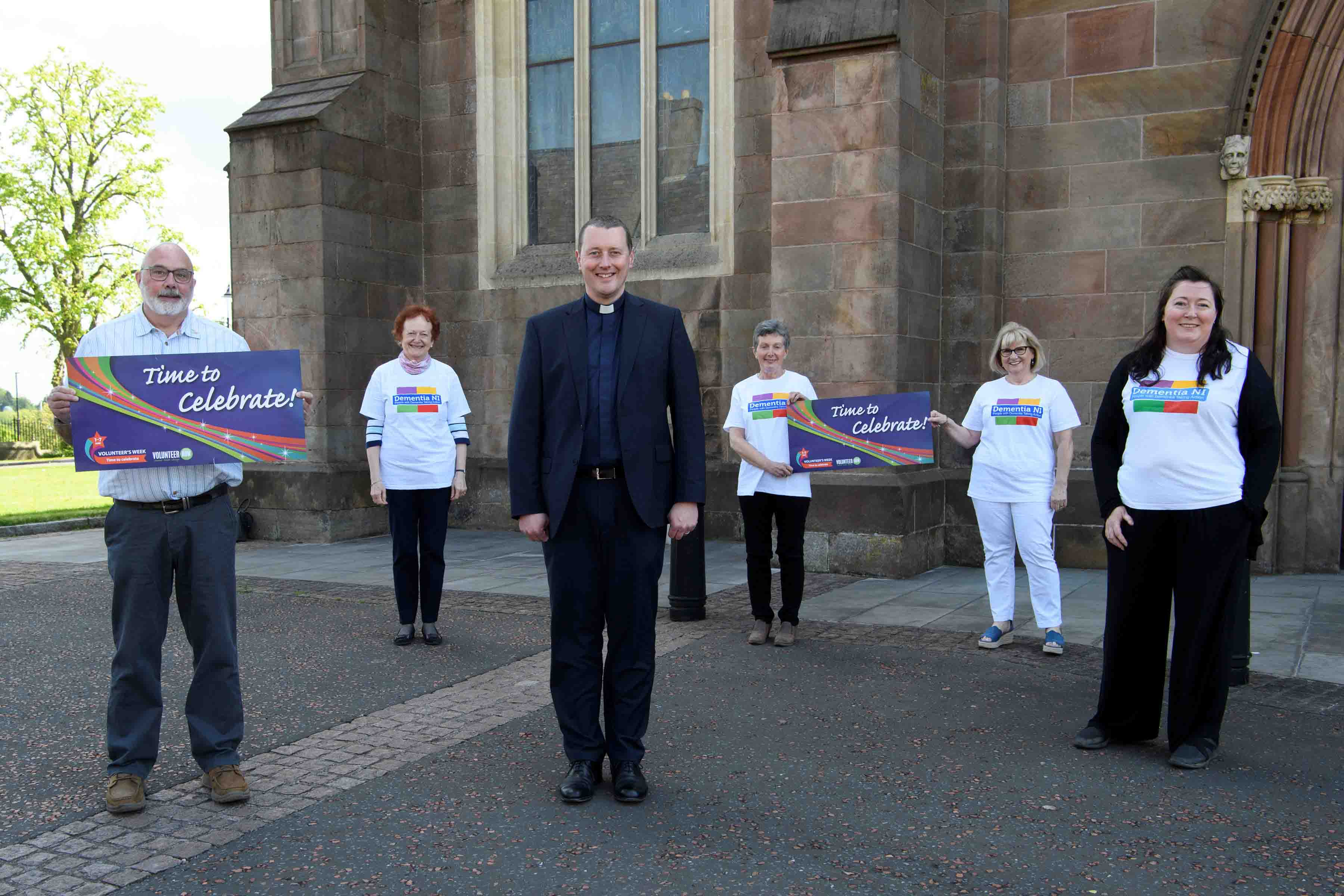 The Very Revd Shane Forster, Dean of Armagh, with Dementia NI volunteers at St Patrick's Cathedral.