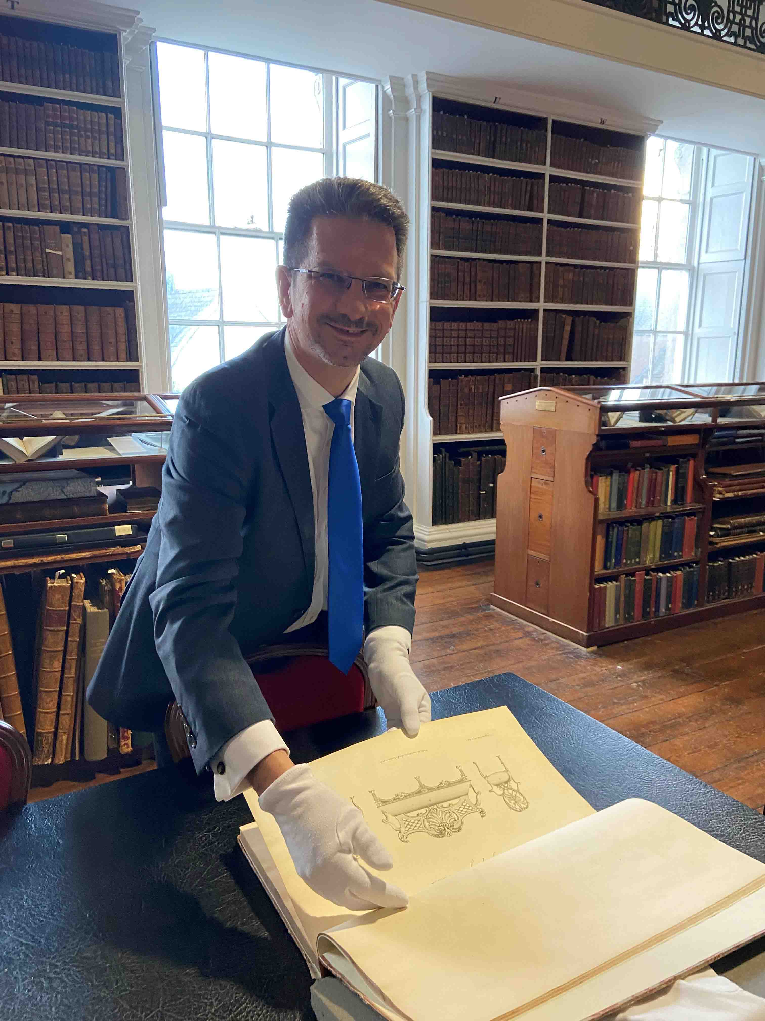 The Minister of State viewing some of the books in Armagh Robinson Library.