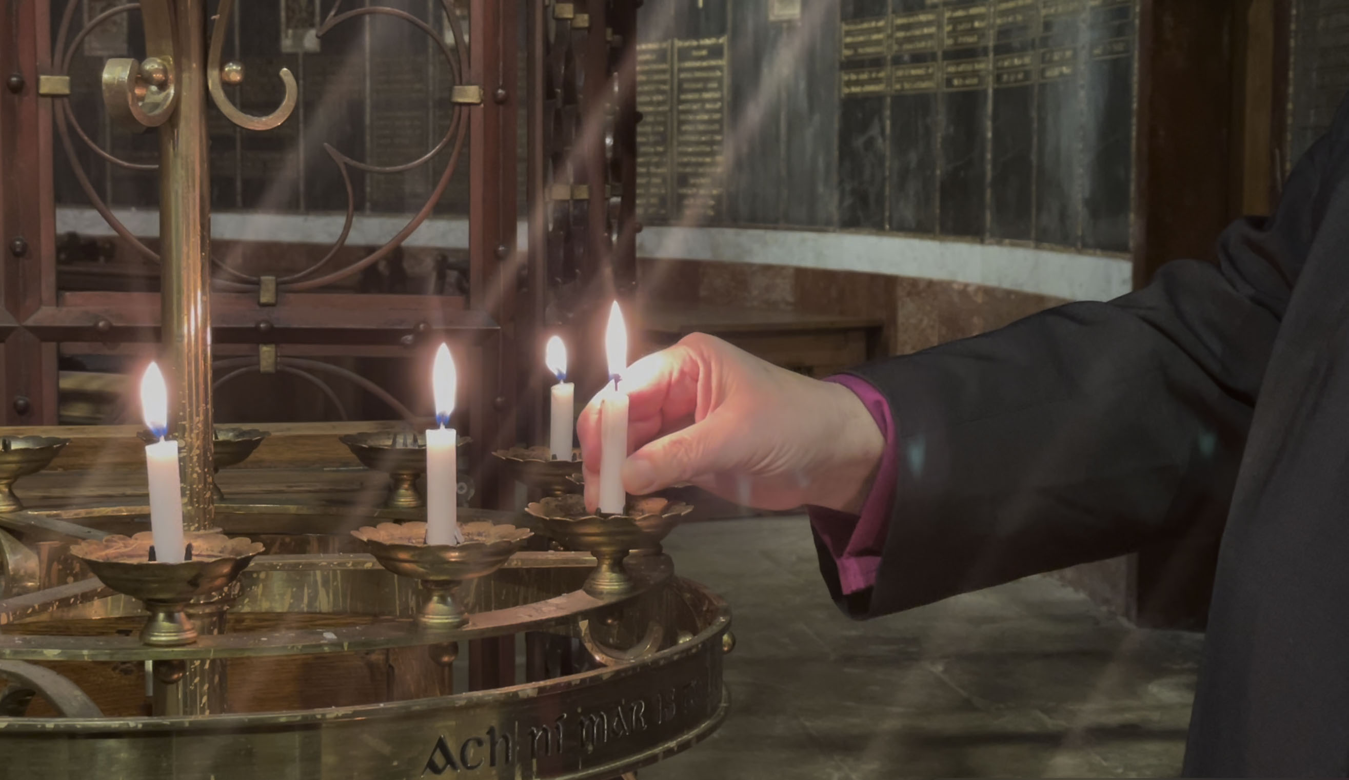 Bishop Paul Colton lighting a candle during the Diocesan Synod 2021 in remembrance of those who died during the Covid-19 pandemic.