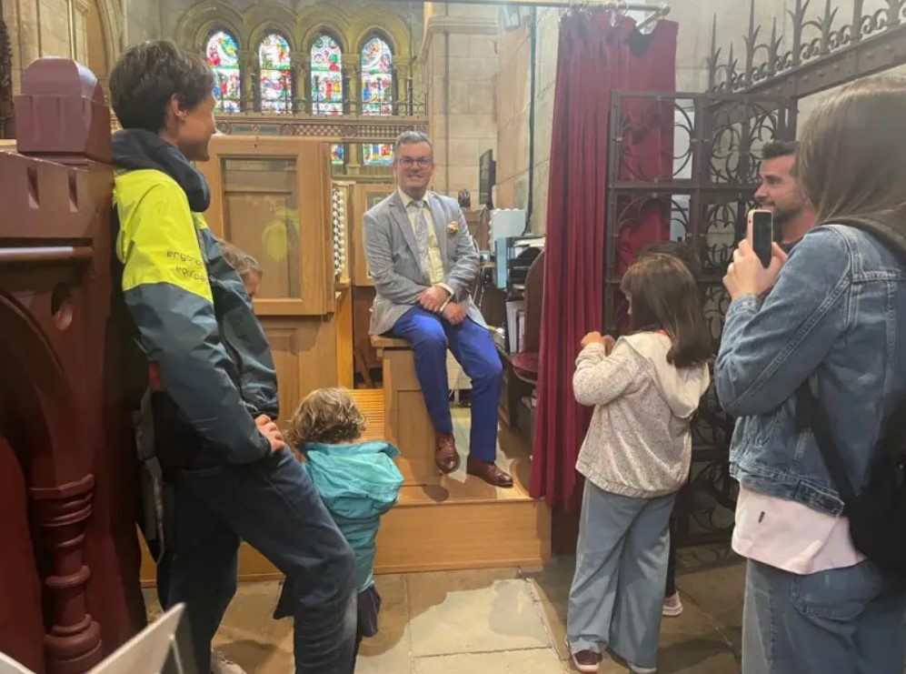 Director of Music Peter Stobart at the Organ with some visitors.