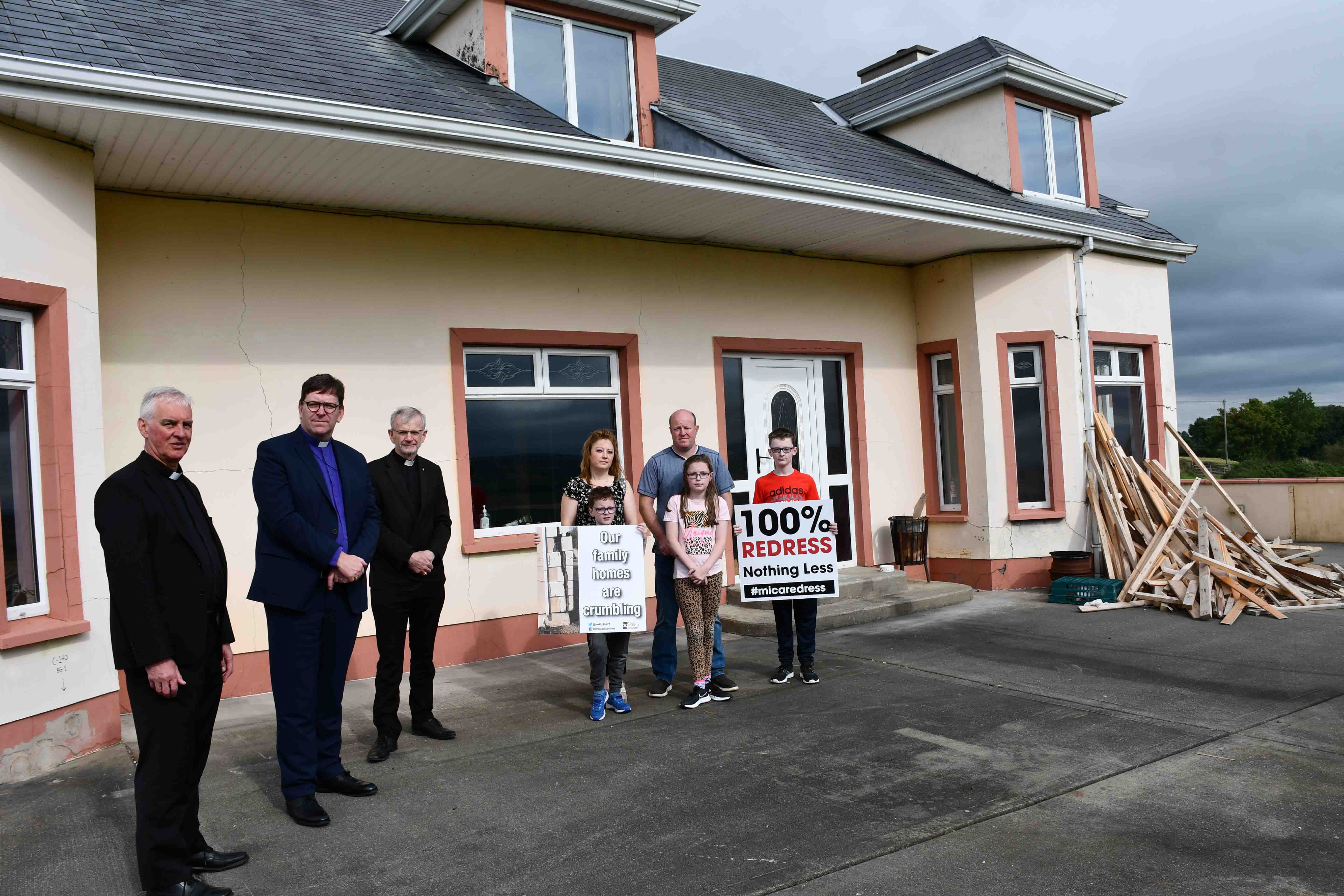 Msgr Michael Canny, Bishop Andrew Forster and Bishop Alan McGuckian outside the O'Donnell family home, near Burnfoot, which is being demolished because it was built with defective blocks.