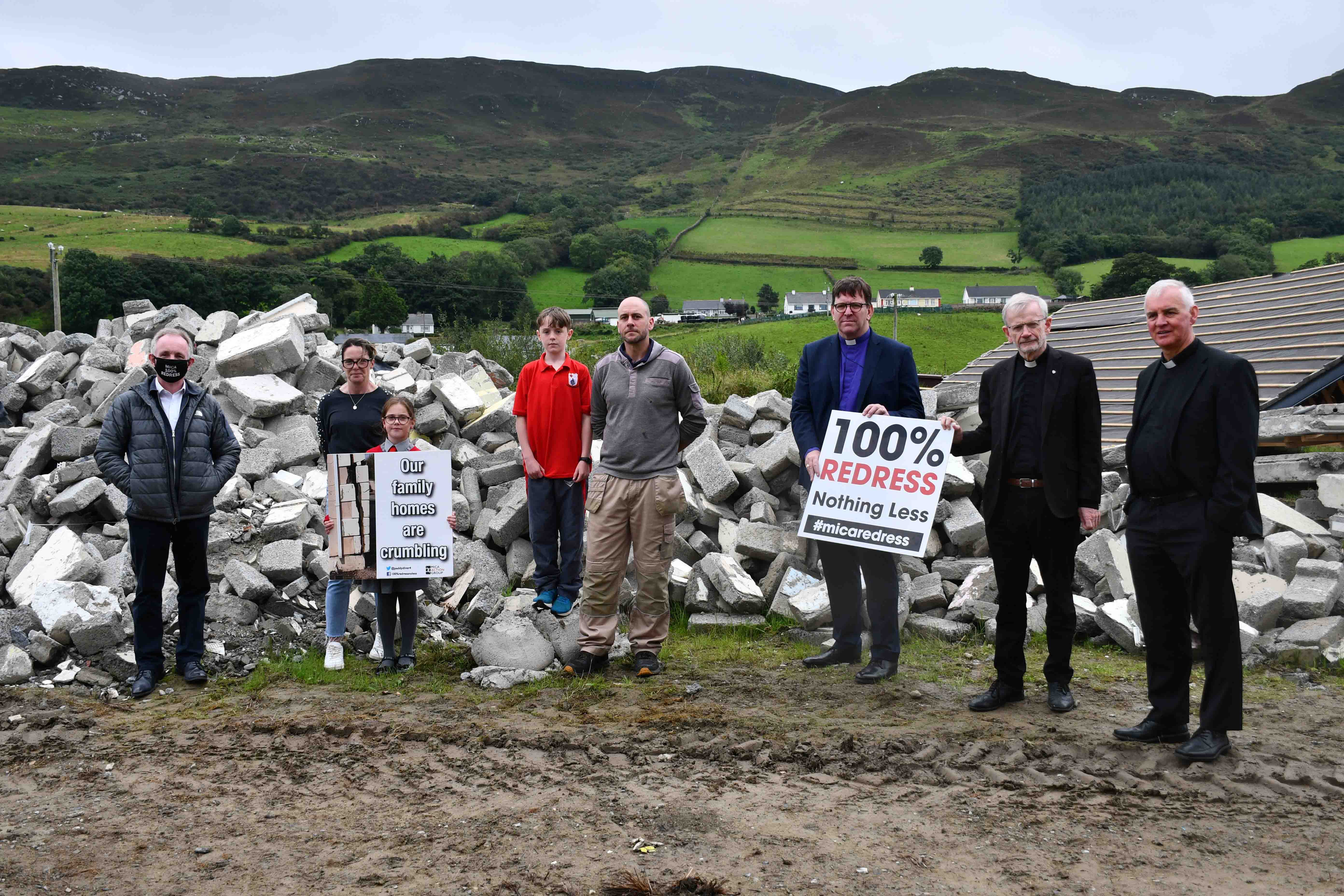 The three church leaders surveyed rubble that was removed from the Breslins' home, at Ludden, near Buncrana, after the house was demolished because of the mica crisis. The family have moved into a temporary home on the site.