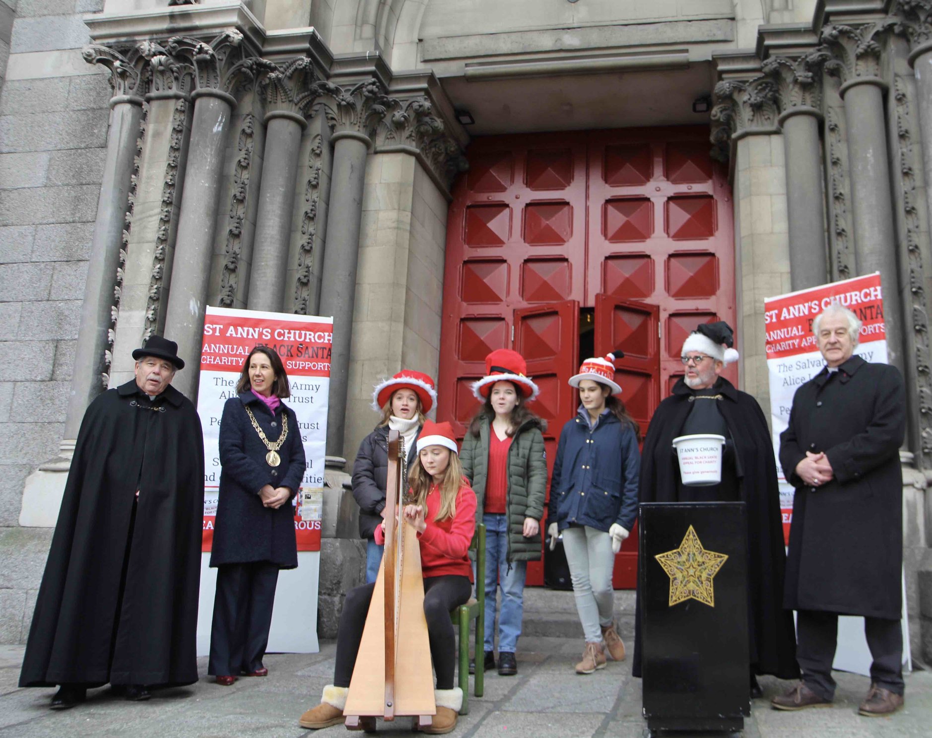Students from Alexandra College Dublin at the launch of the 2021 Black Santa Appeal pictured with the Revd Terry Lilburn, Lord Mayor Alison Gilliland, Black Santa Fred Deane and Archbishop Michael Jackson.