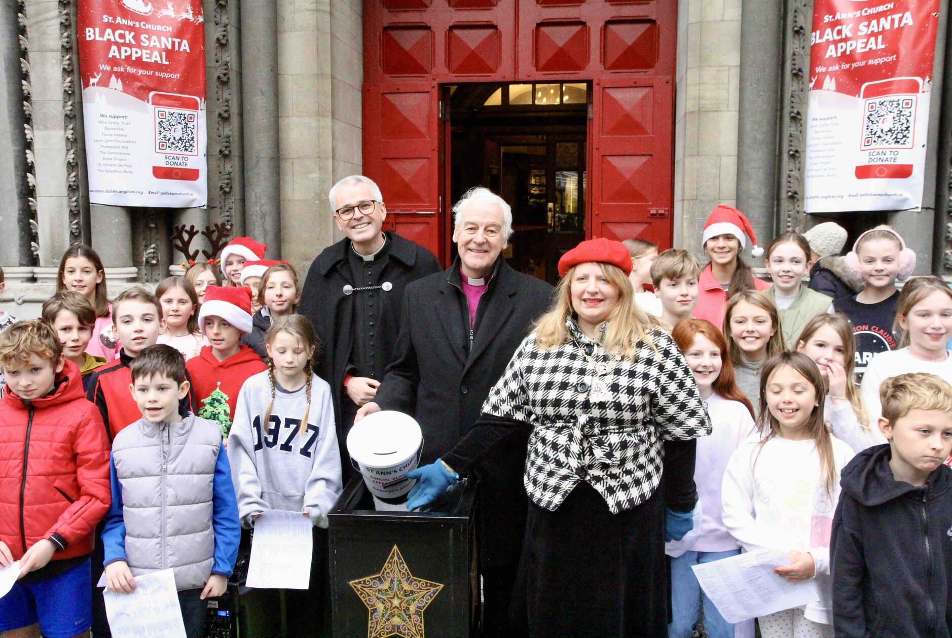 The choir of Kildare Place School filled Dawson Street with festive cheer for the Black Santa 2024 launch. They are pictured with Canon Paul Arbuthnot, Archbishop Michael Jackson and Deputy Lord Mayor Donna Cooney.