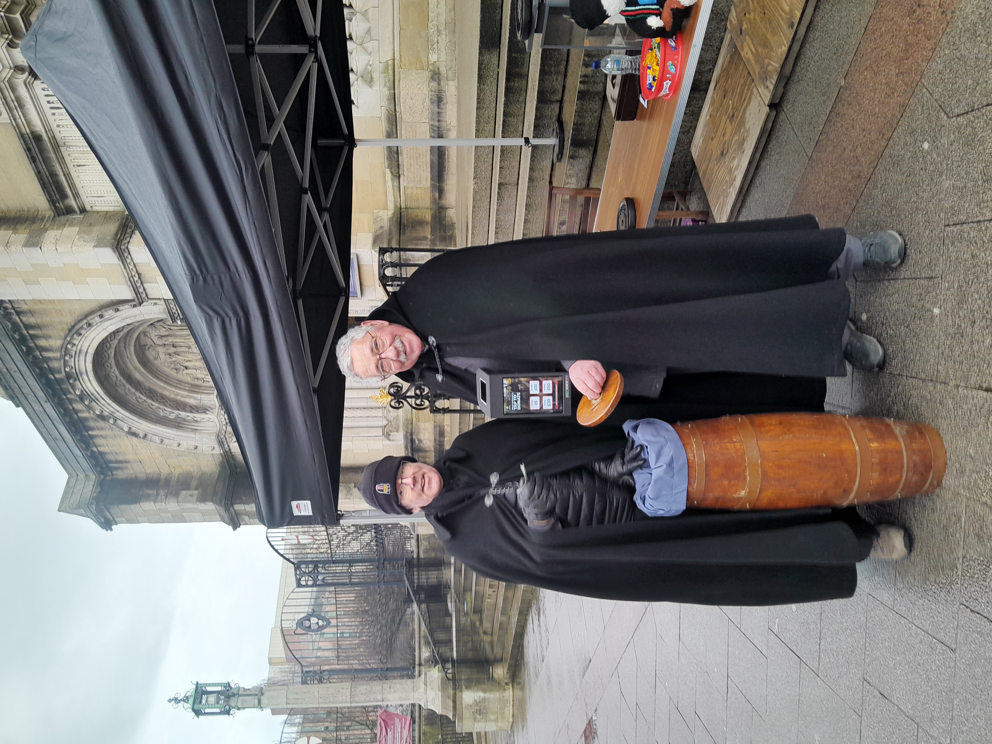 Belfast's Black Santa, Dean Stephen Forde, and Bishop Trevor Williams welcoming donations today outside Belfast Cathedral, on Donegall Street.