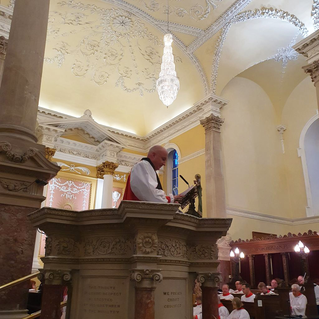 The Bishop preaching his sermon about the important differences between remembrance and preservation.