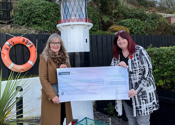 Carolyn Moore, right, presents the &pound;3,015 she raised through the coffee morning to Dawn McConnell from Hope House.