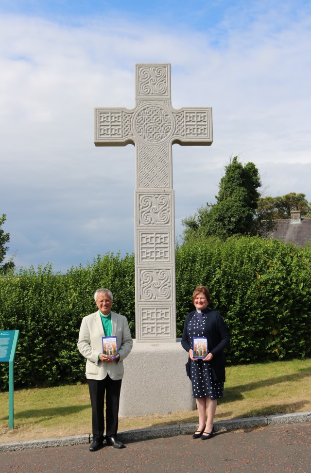 The Very Revd Henry Hull, Dean of Down, and the Revd Karen Salmon pictured with 'St Patrick's Pilgrimages &ndash; Journey to Place, Journey to God' at St Patrick's High Cross, a replica of the 8th Century original, at Down Cathedral, Downpatrick.