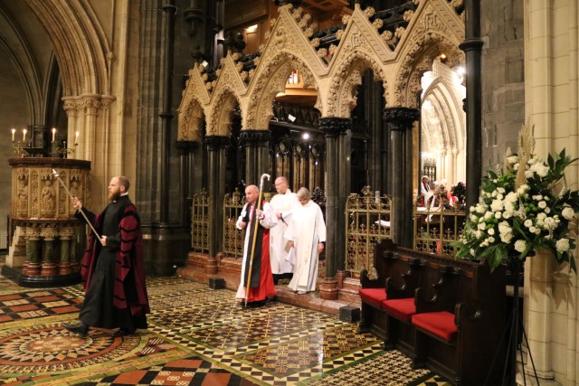 In procession.