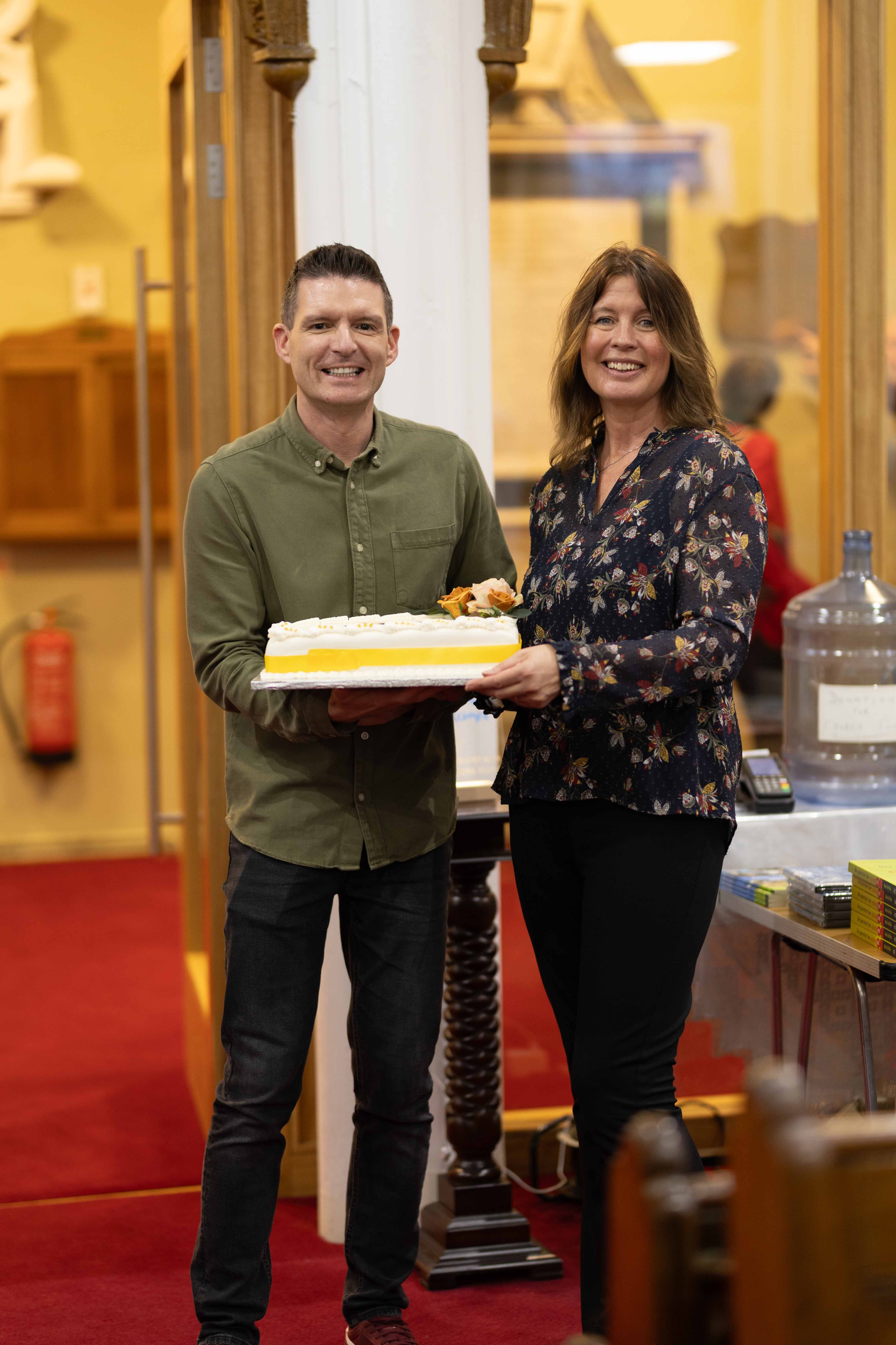 National Youth Officer Simon Henry and National Children and Families Ministry Development Officer Rachael Murphy present the celebratory cake baked for the occasion!  Photo credit: Frank Dillon Photography.