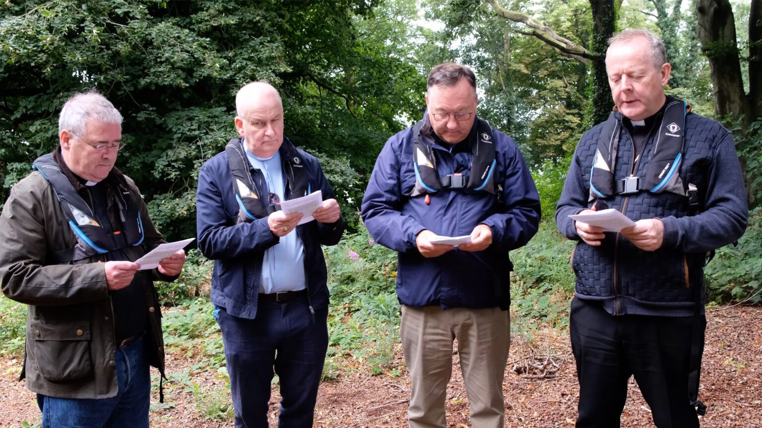 Archbishop John McDowell, the Revd Alan Wardlow, the Rt Revd Dr Trevor Gribben, and Archbishop Eamon Martin praying on Coney Island as part of their visit to Lough Neagh.