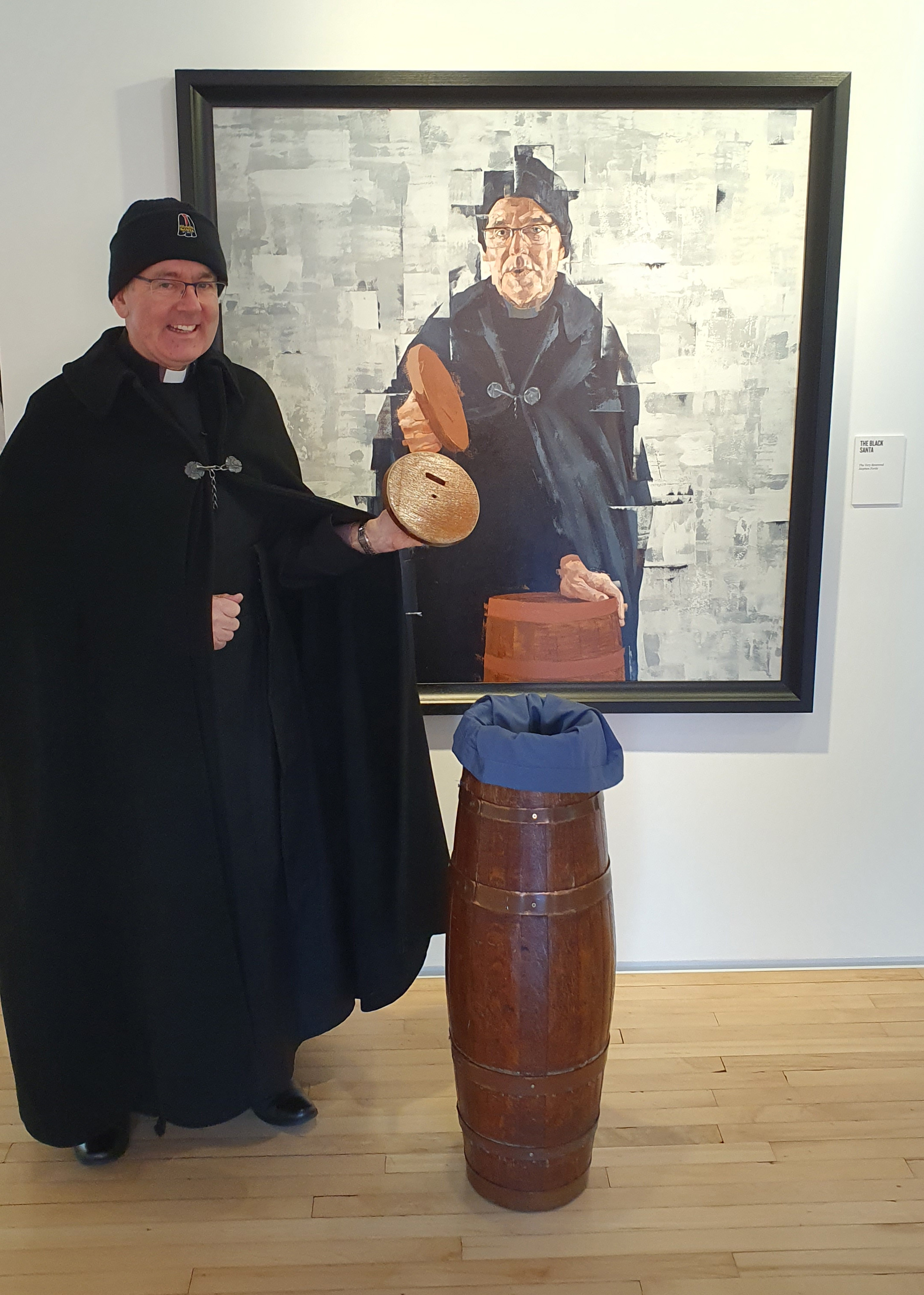 Dean Stephen Forde with his portrait by Ciaran Gallagher in the Sea Holly Gallery.