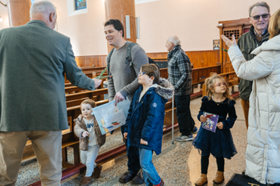 Giving out St Brigid's crosses after the service