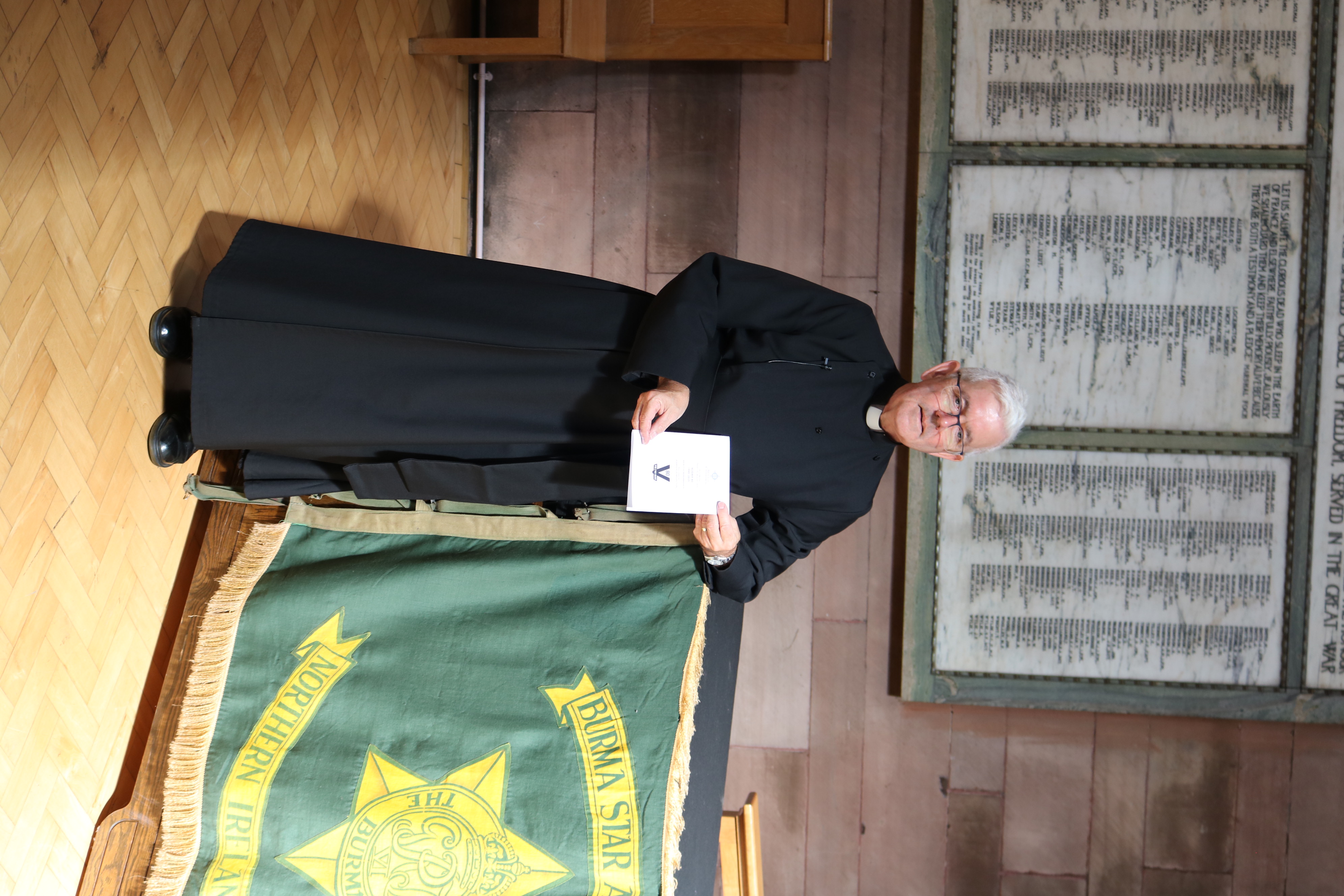Dean Stephen Forde with the banner of the Burma Star Association.