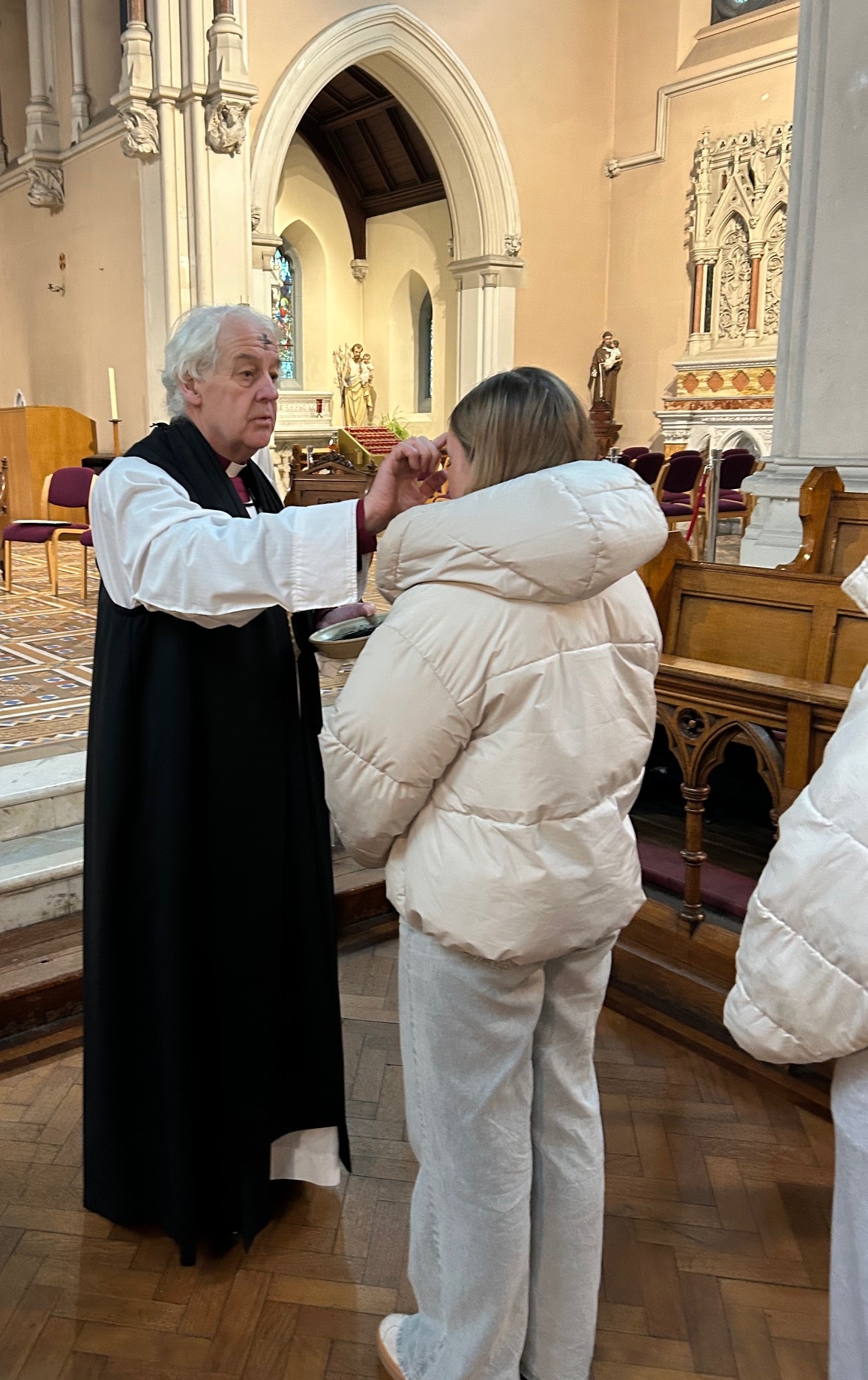 Archbishop Michael Jackson distributes ashes to a member of the congregation at the Ash Wednesday Service at DCU All Hallows.